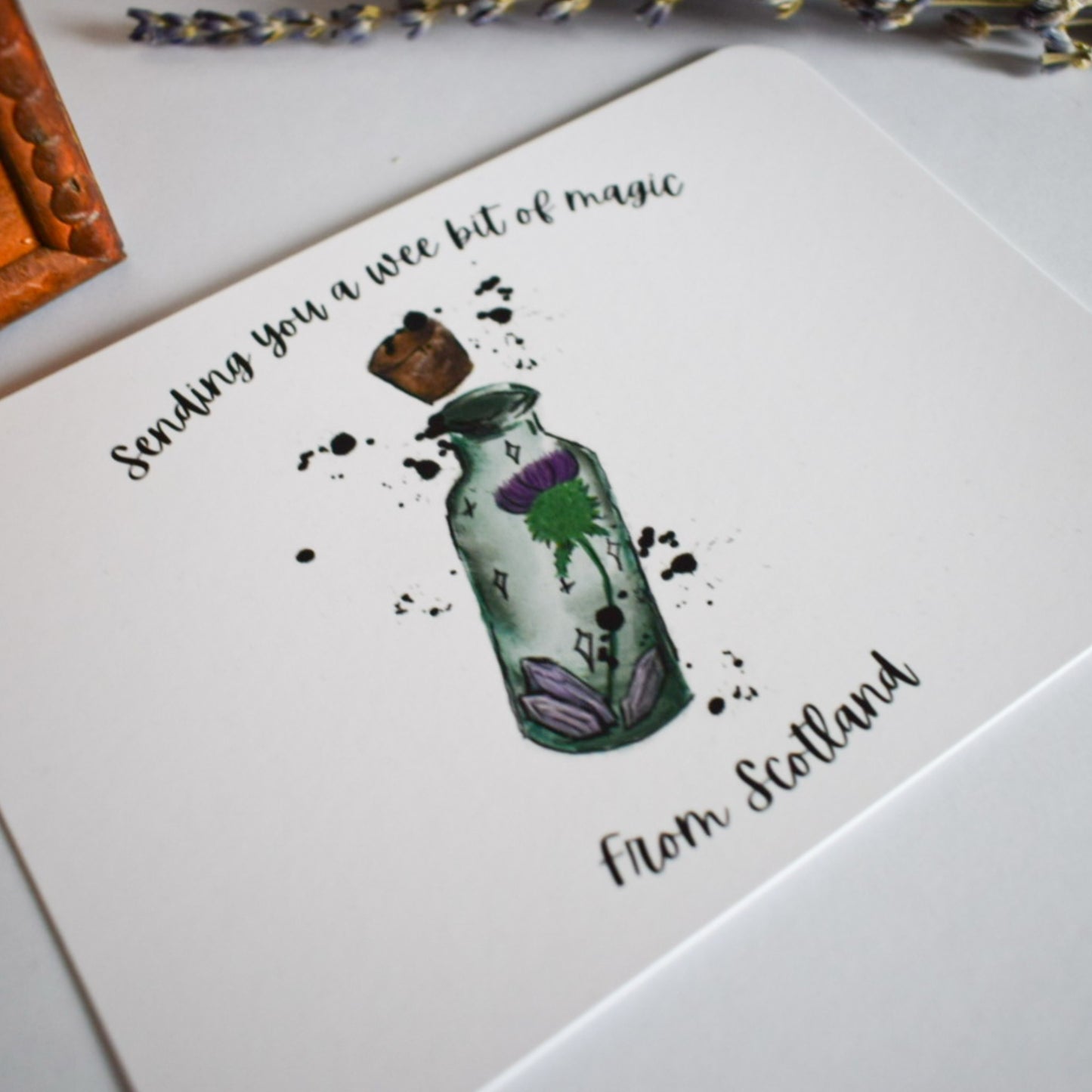 Greeting card with a bottle illustration and text on a white surface