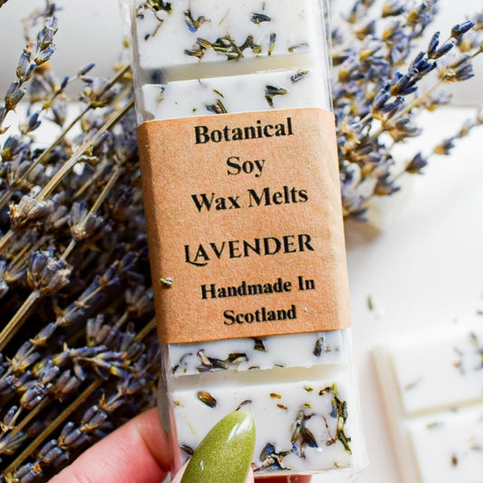 Botanical soy wax melts with lavender scent, handmade in Scotland, surrounded by lavender flowers.