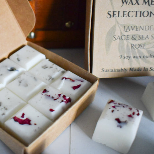 Box of soy wax melts with dried flowers, next to a box labeled 'Wax Melts Selection'.