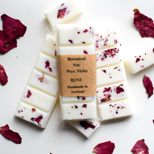 Botanical soy wax melts with rose petals on a white background