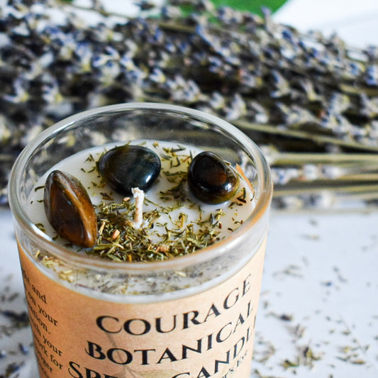 Candle in a glass jar with botanicals and lavender in the background
